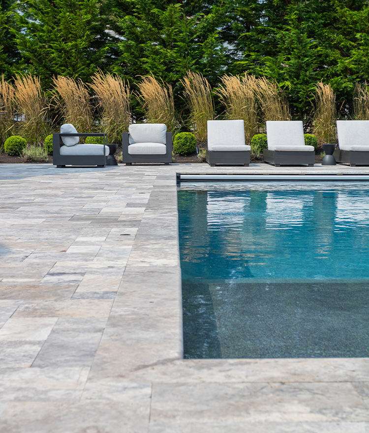 Large travertine paver display around a pool deck
