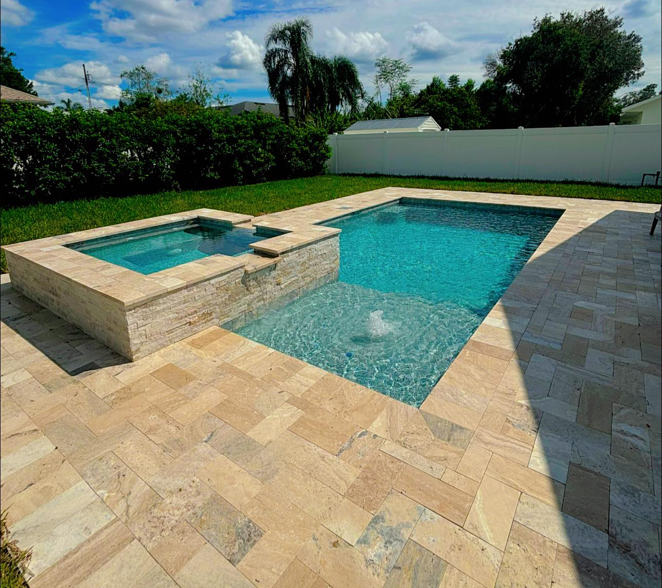 Travertine pavers around a Florida pool deck